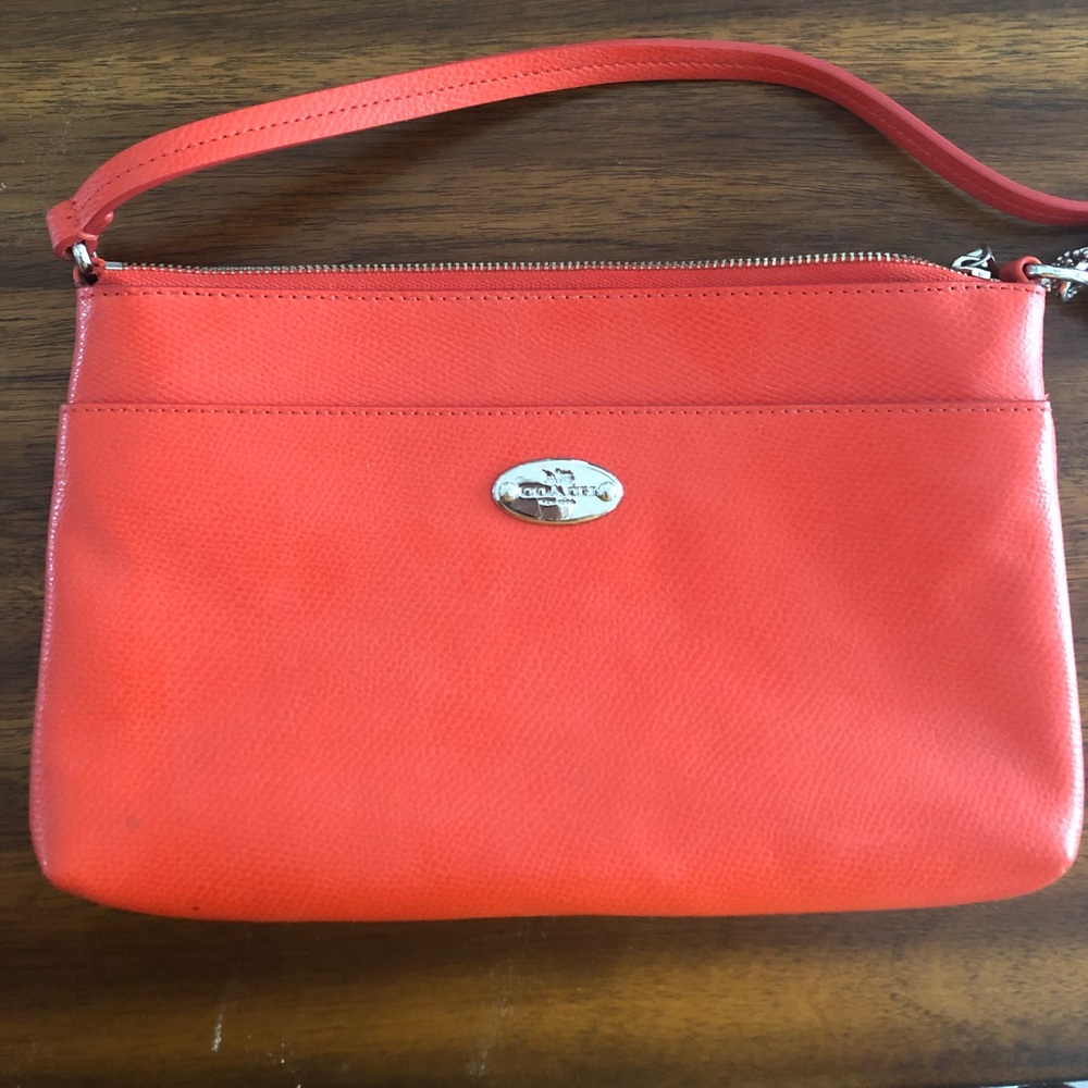 Orange/coral Coach Clutch.